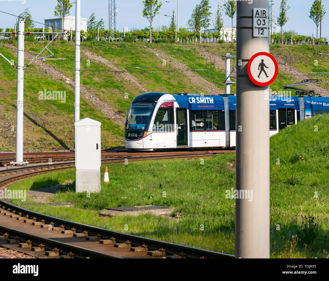 Edinburgh tram arriving at tram stop, Edinburgh Gateway, Edinburgh