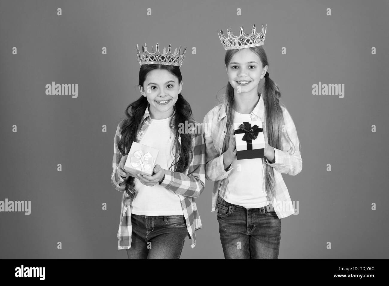 Egocentric princess. Kids wear golden crowns symbol princess. Every girl dreaming become princess. Little princess. Happy childhood. We deserve only best. Girls wear crowns. Spoiled children concept. Stock Photo