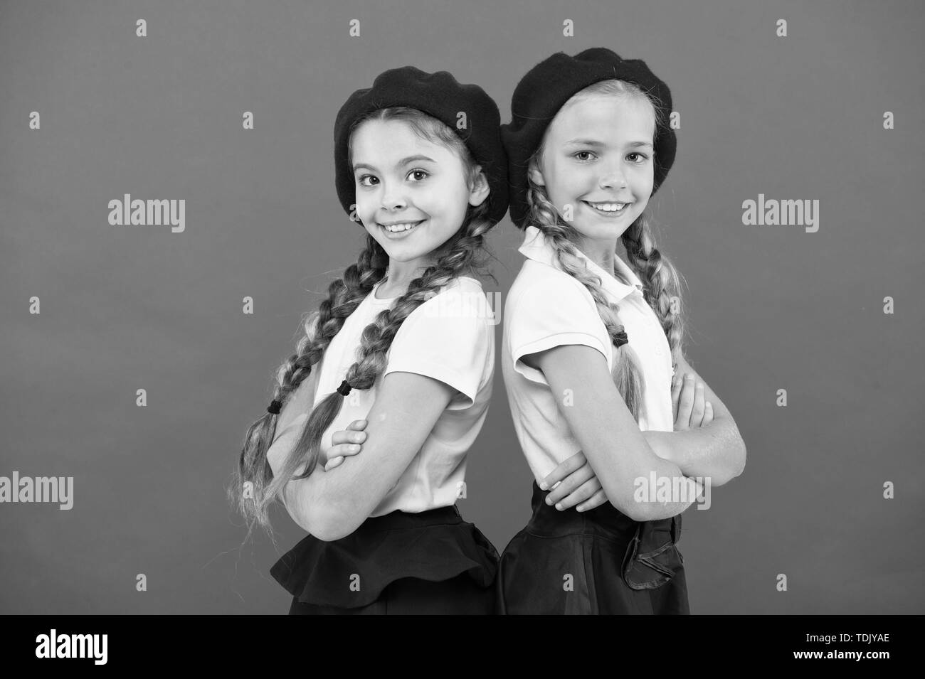 School fashion concept. Schoolgirls wear formal uniform and beret hats