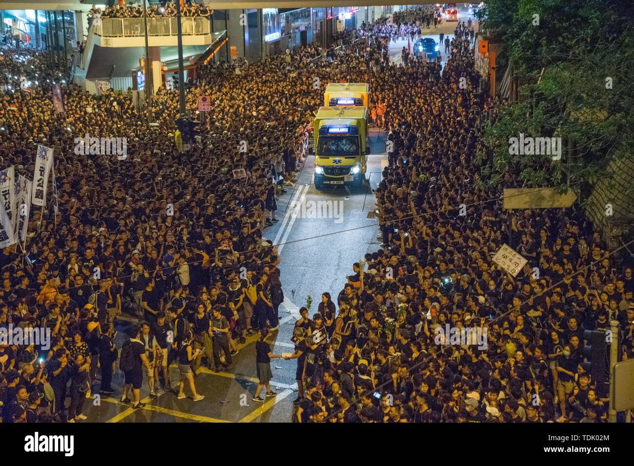 Protesters made way for an ambulance when they marched through the streets of Hong Kong during the mass rally, which called for, among other demands, the withdrawal of the controversial extradition bill and the resignation of Chief Executive Carrie Lam. Despite the Chief Executive Carrie Lam's attempt to ease the heightened tension by agreeing to suspend the controversial bill, close to 2 million people participated in Sunday's rally, according to the organizers. The protesters called for the withdrawal of the controversial extradition bill, the release and non-prosecution of the people arrest Stock Photo
