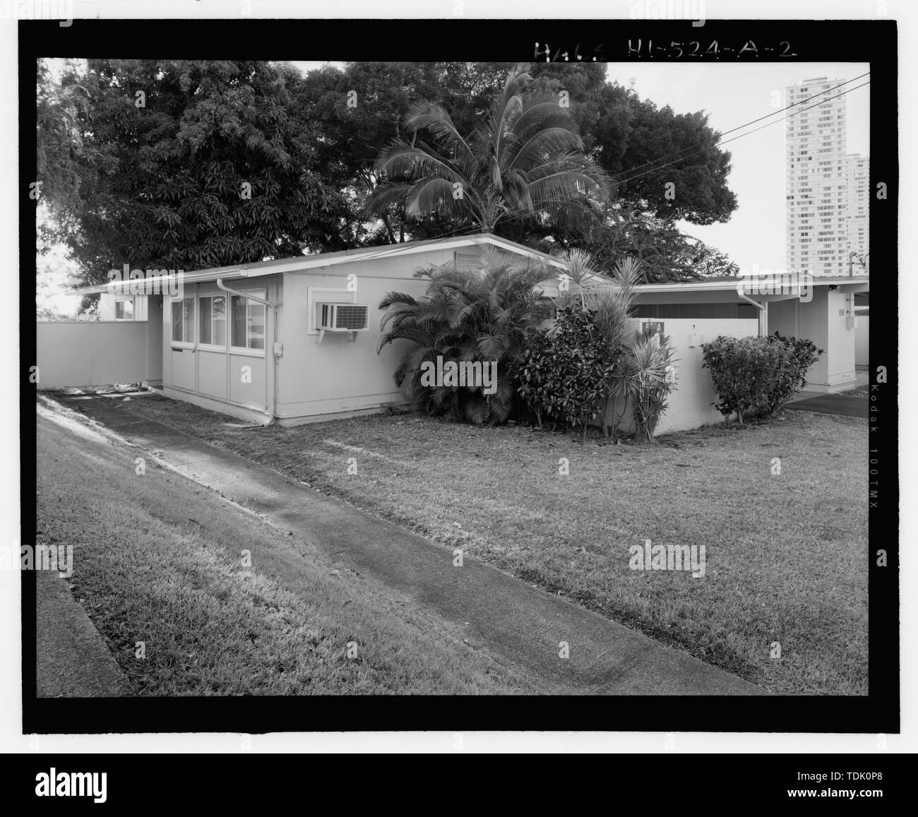 OBLIQUE VIEW OF NORTHEAST CORNER UNIT A. NOTE THE ADDED OPENING WITH AIR CONDITIONER. VIEW FACING SOUTHWEST - CAMP H.M. SMITH AND NAVY PUBLIC WORKS CENTER MANANA TITLE VII; (CAPEHART) HOUSING, U-SHAPED TWO-BEDROOM DUPLEX TYPE 1, Acacia Road, Birch Circle, and Cedar Drive, Pearl City, Honolulu County, HI Stock Photo