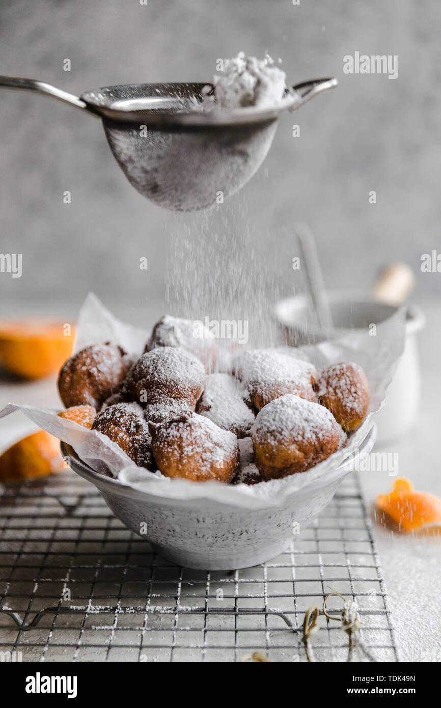 Cara cara fritters, with chocolate dipping sauce and powdered sugar Stock Photo