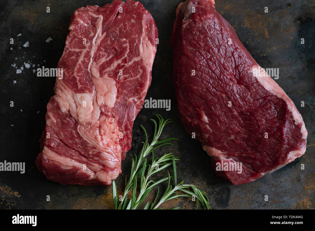 Raw black angus prime beef steak variety with rosemary, sea salt and spices Stock Photo