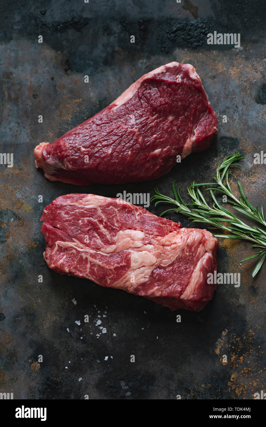 Raw black angus prime beef steak variety with rosemary, sea salt and spices Stock Photo