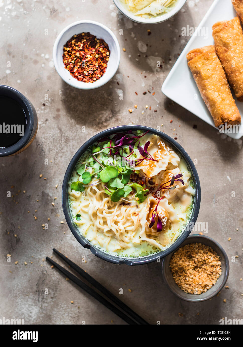 Asian dinner set ramen noodle soup with pork dumplings, egg rolls and