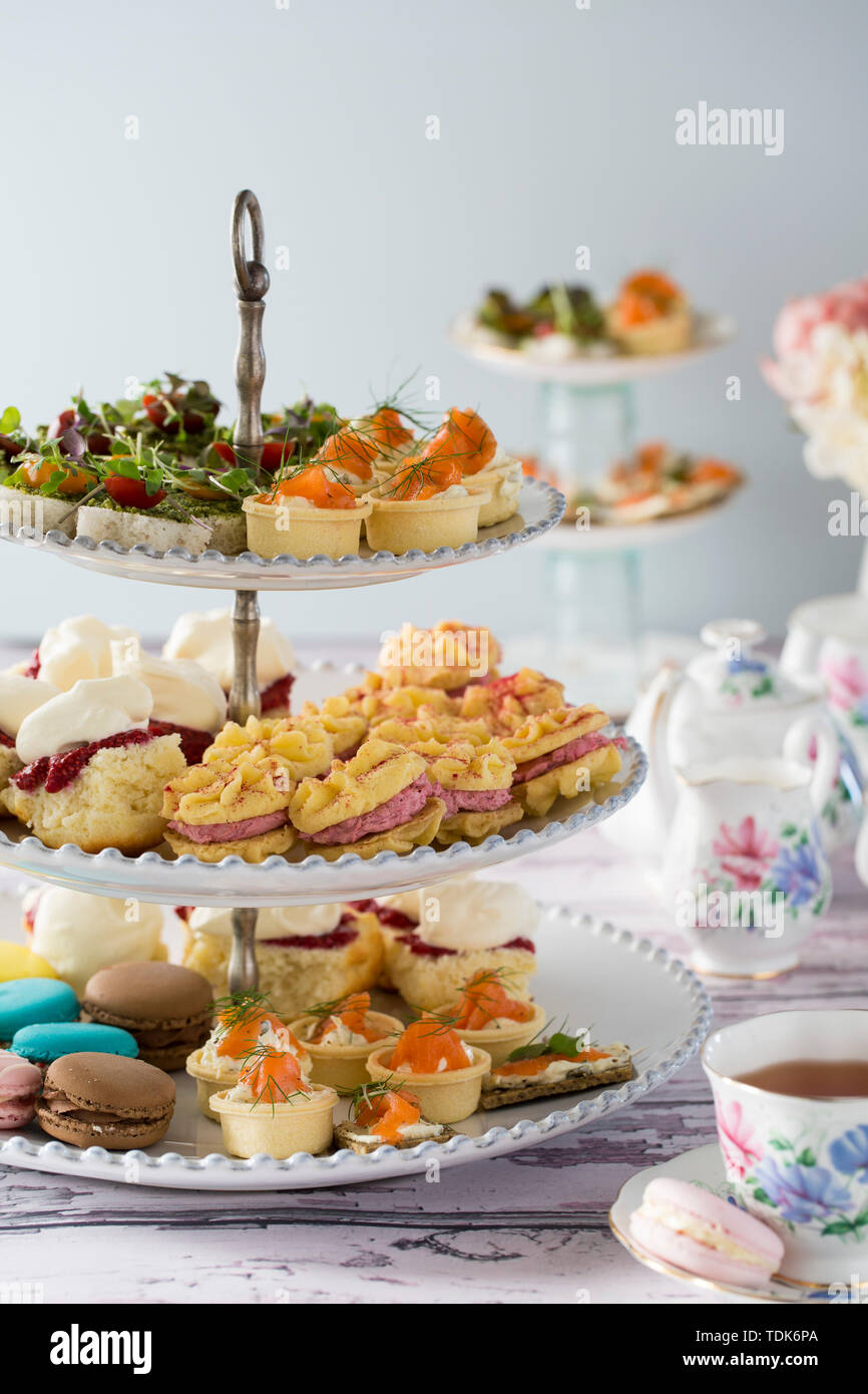 High Tea, or Afternoon Tea laid out on a table with traditional cups and  saucers Stock Photo - Alamy