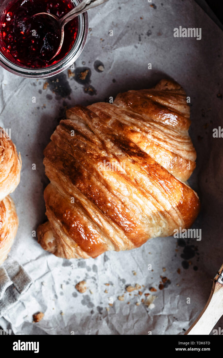 A single french croissant ready to be filled with jam Stock Photo Alamy