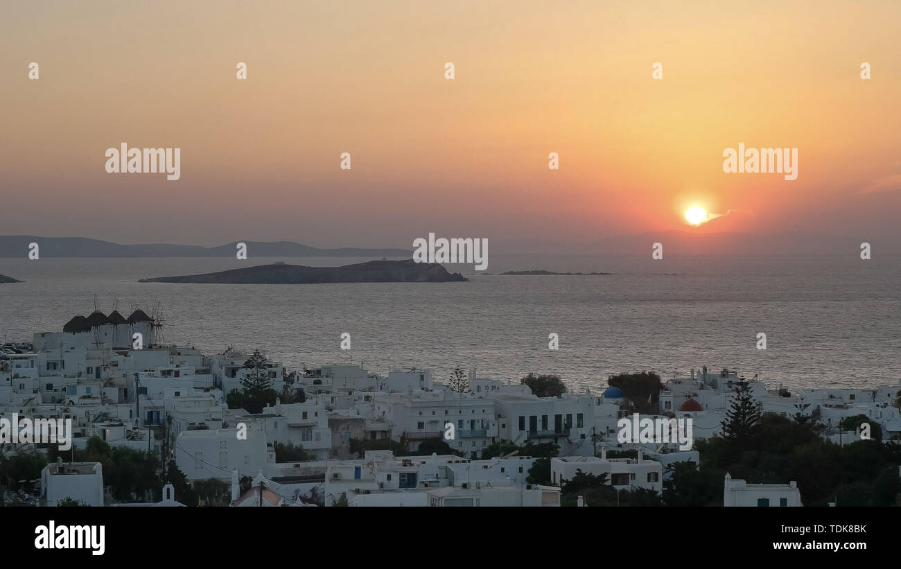 the sun sets at the village of chora on mykonos, greece Stock Photo
