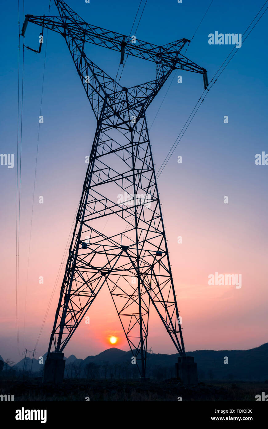 A transmission tower under the sunset Stock Photo - Alamy