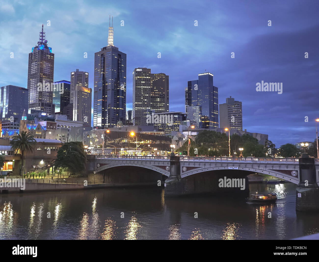 MELBOURNE, AUSTRALIA-NOVEMBER, 12, 2016: night shot of a ferry passing under a bridge on melbourne's yarra river in the australian state of victoria Stock Photo