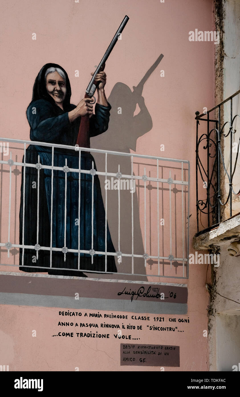 Oliena, Italy. 08th June, 2019. A wall painting painted on a house wall showing Maria Palimodde by the artist Luigi Columbu is one of the famous large-format murals 'Murales' in the streets of this region. Topics are both international events such as the Vietnam War, the partisan struggle during fascism and local events. One of the most important is the successful struggle of the population against a military training area planned by NATO in 1969 on the Pratobello plateau. Credit: Jens Kalaene/dpa-Zentralbild/ZB/dpa/Alamy Live News Stock Photo