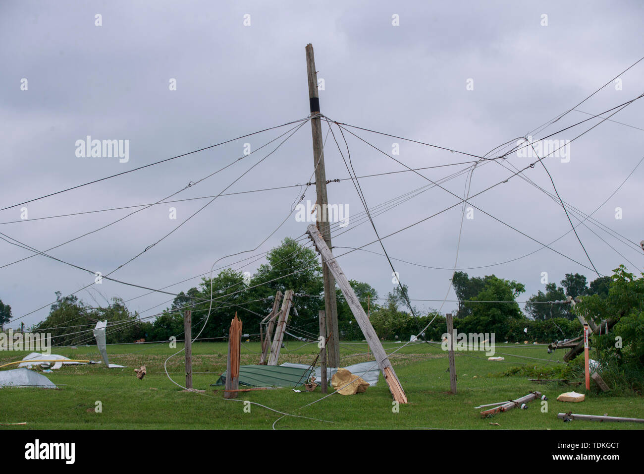 Ellettsville, Indiana, USA. 16th June, 2019. Utility lines tangled along Ind. 46 near Flatwood Rd., during the aftermath. A tornado struck the area leaving a patch of damage from Greene County to Northern Monroe County destroying trees, homes, cars, and leaving a path of debris and live power lines on the ground in its wake. Credit: SOPA Images Limited/Alamy Live News Stock Photo