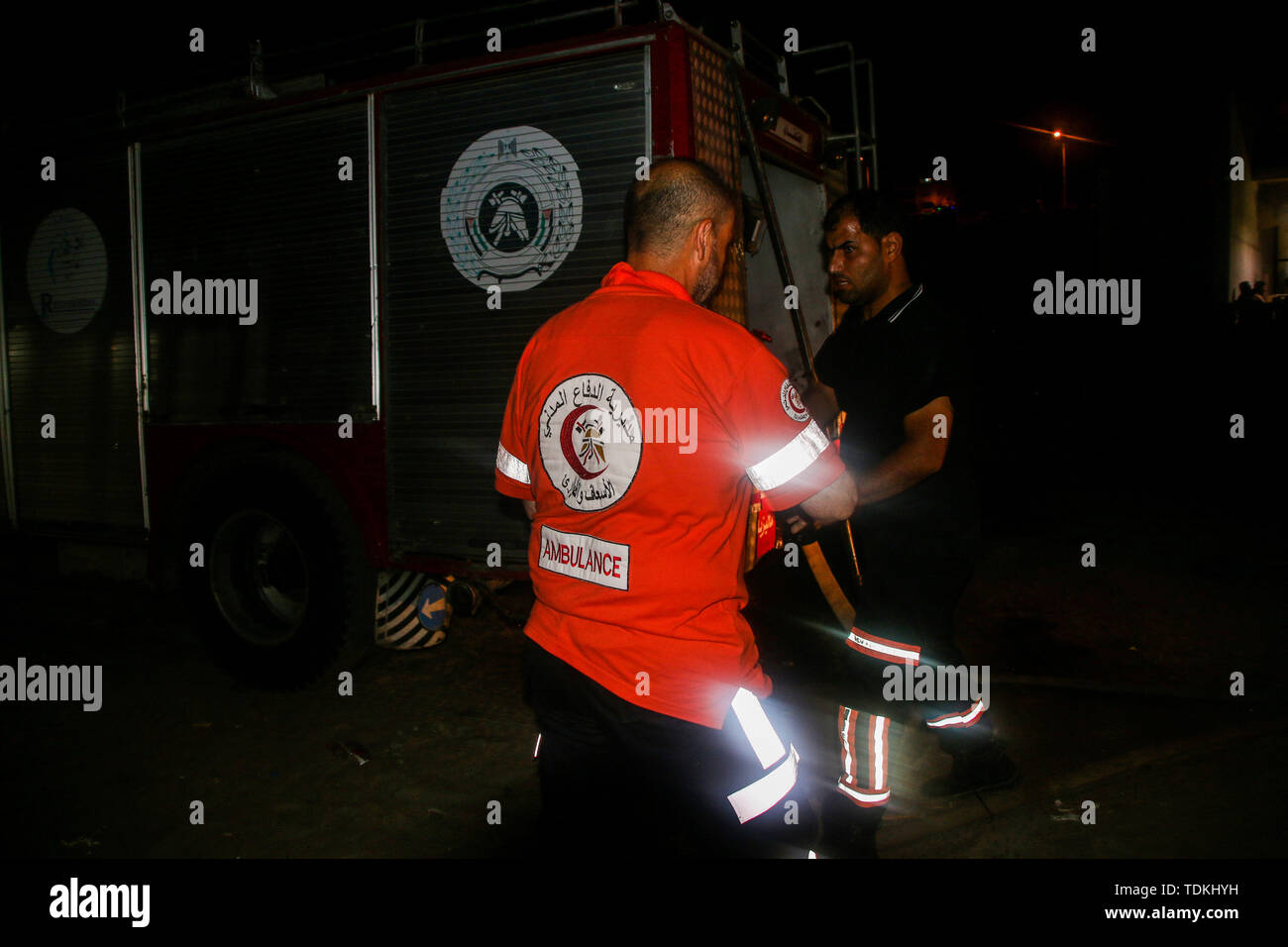 A firefighter crew extinguish a fire which broke out at the seafront in Gaza City with a young girl suffering a head injury. 16th June, 2019. Red Crescent paramedics also attended the site of the accident to provide medical assistance to the injured child Credit: Ahmad Hasaballah/IMAGESLIVE/ZUMA Wire/Alamy Live News Stock Photo