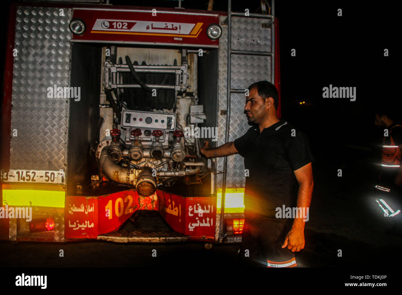 A firefighter crew extinguish a fire which broke out at the seafront in Gaza City with a young girl suffering a head injury. 16th June, 2019. Red Crescent paramedics also attended the site of the accident to provide medical assistance to the injured child Credit: Ahmad Hasaballah/IMAGESLIVE/ZUMA Wire/Alamy Live News Stock Photo