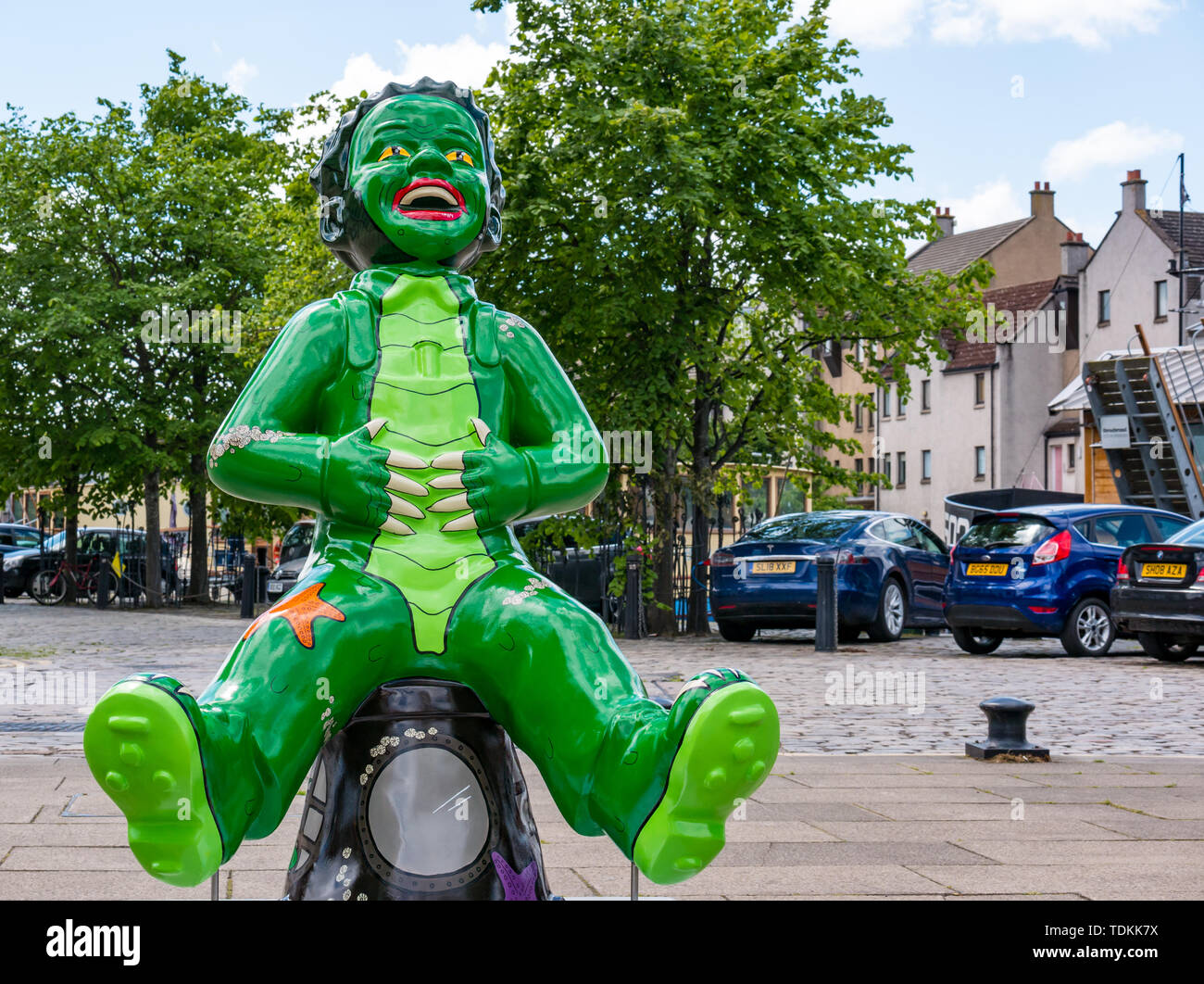 Leith, Edinburgh, Scotland, United Kingdom, 17 June 2019. Oor Wullie's Big Bucket Trail: An art trail of 200 Oor Wullie sculptures appear in Scottish cities in a mass arts event that lasts until August 30th. Oor Wullie is an iconic Scottish cartoon character from the Sunday Post newspaper. The sculptures will be auctioned to raise money for Scotland’s children’s hospital charities There are 5 in the Leith area, and 60 in Edinburgh altogether. Wullie from the Black Lagoon by Ruairidh Brunton Stock Photo