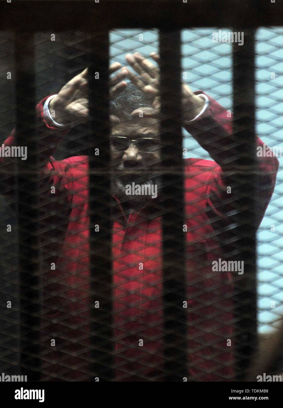 May 7, 2009 - Cairo, Cairo, Egypt - FILE PHOTO: Ousted Egyptian president Mohammed Morsi gestures as he sits behind bars during his trail as part of the so-called 'Qatar espionage' case, in a court in Cairo on january 2, 2015. Former President Mohamed Morsi died on Monday in court after the conclusion of a trial session in the espionage lawsuit, Egyptian state TV said  (Credit Image: © Amr Sayed/APA Images via ZUMA Wire) Stock Photo