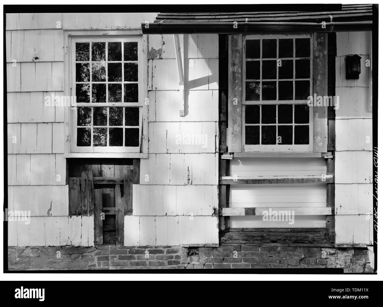 Original window on right being re-installed, on northeast corner of