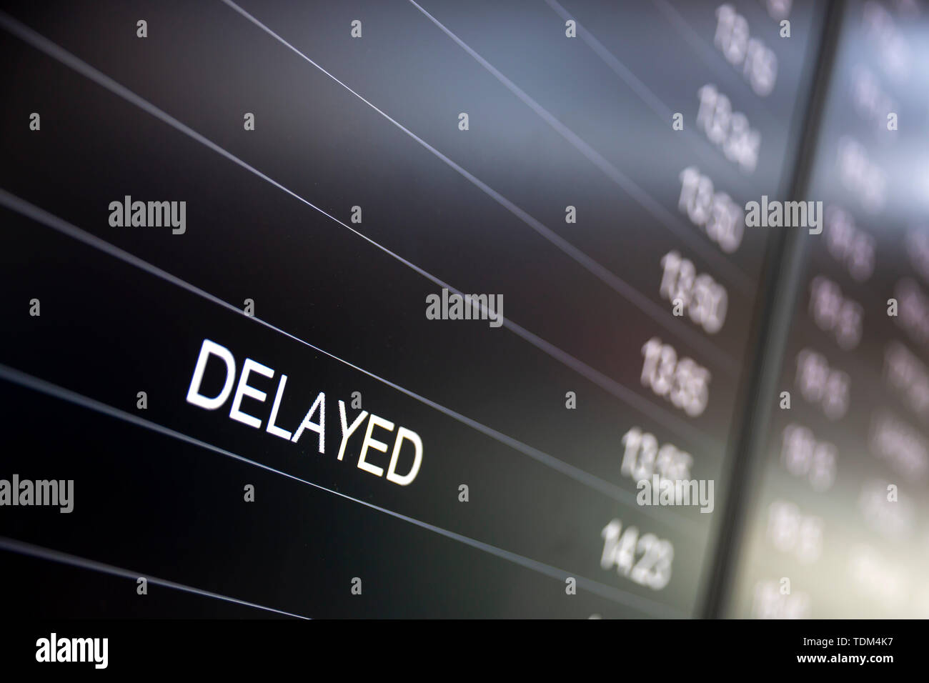 Boarding time monitor screens - timetable boards. Arrivals and departures monitors to check the status of a flight on the airport. Delayed sign. Stock Photo