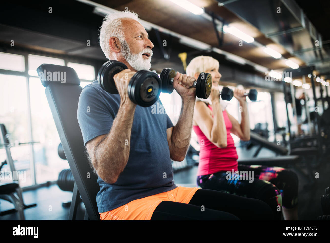 Happy senior people doing exercises in gym to stay fit Stock Photo - Alamy
