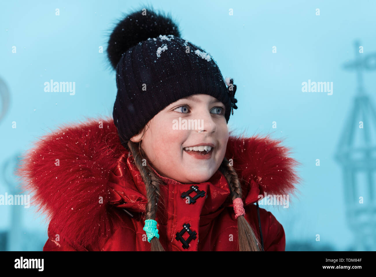 winter portrait of a beautiful little girl. happy baby in hat smiling