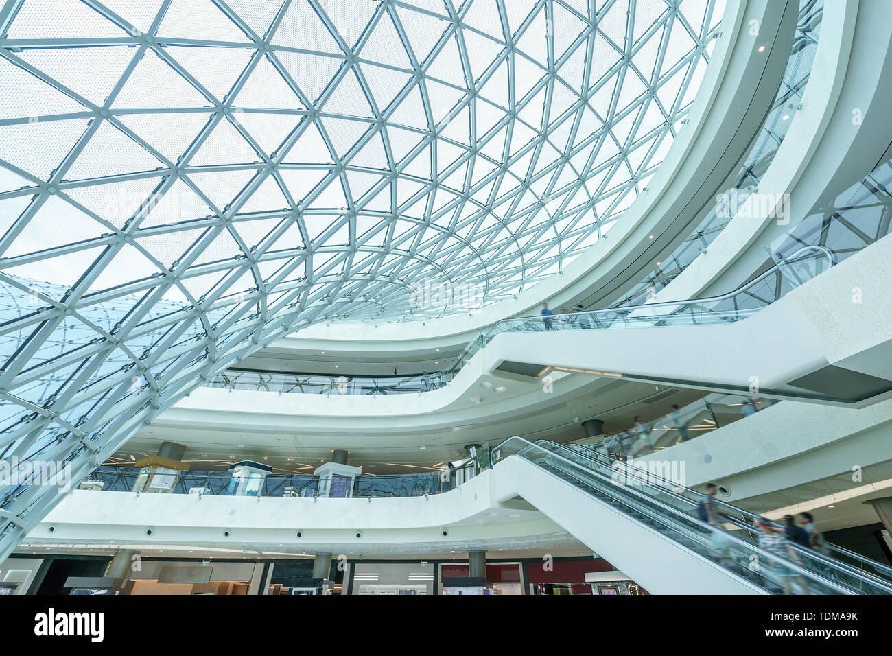 Side Of Glass Building And Escalator In Modern Hall Stock Photo