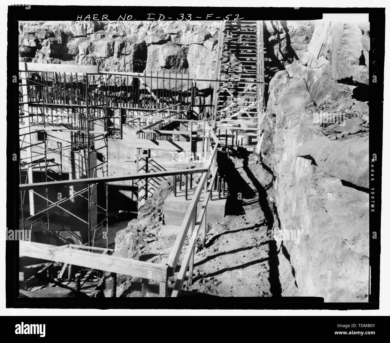 PBF Reactor Building (PER-620). Construction view shows native lava rock surrounding basement excavation and general complexity of planning required to build the PBF. A three-inch low-pressure air line protrudes from wall just below left center. Date- February 21, 1967. Photographer- Larry Page. INEEL negative no. 67-1125 - Idaho National Engineering Laboratory, SPERT-I and Power Burst Facility Area, Scoville, Butte County, ID Stock Photo
