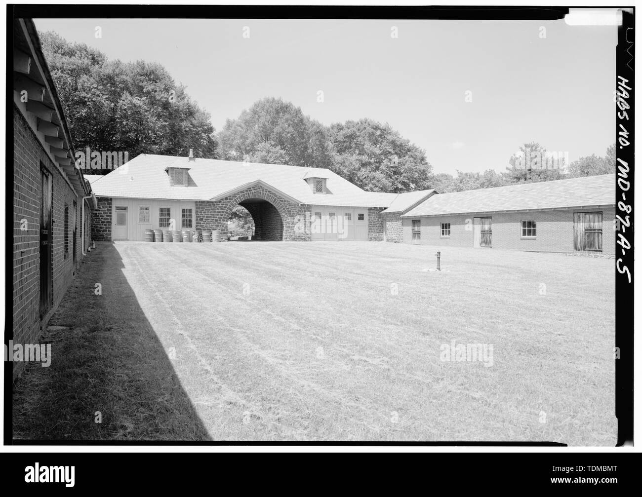 PERSPECTIVE VIEW FROM EXERCISE YARD OF EAST (REAR) AND NORTH WING LOOKING NORTHWEST (NOTE- AREA TO LEFT OF CENTER ARCH IS THE CARETAKER'S DWELLING, AND TO THE RIGHT, THE CARRIAGE HOUSE) - Belair, Stables, Belair Drive at East end of Tulip Grove Drive, Bowie, Prince George's County, MD; Woodward, James T; Levitt and Sons; Klugh, T, transmitter; Boucher, Jack E, photographer; Lavoie, Catherine C, historian Stock Photo