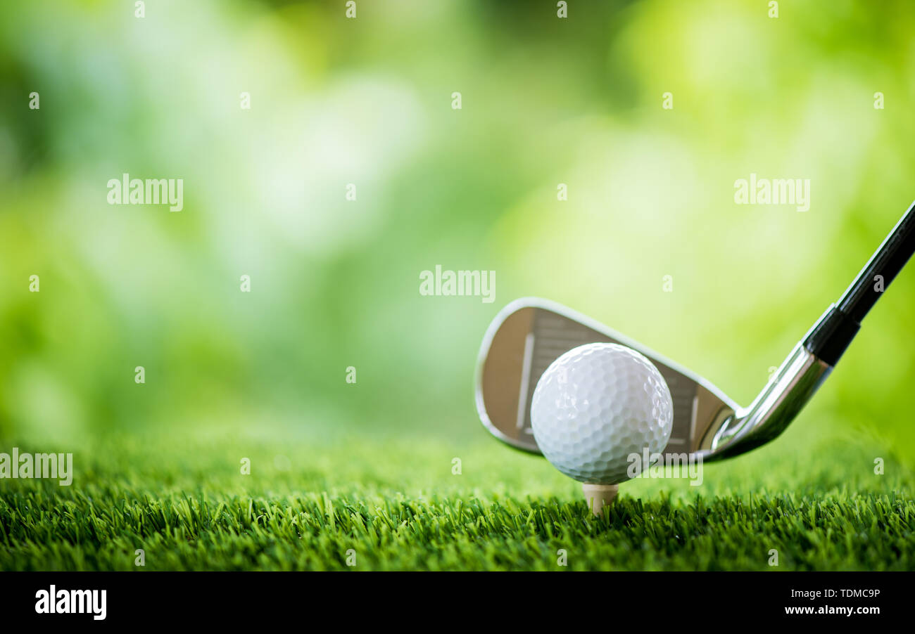 golf ball on tee with club to tee off Stock Photo