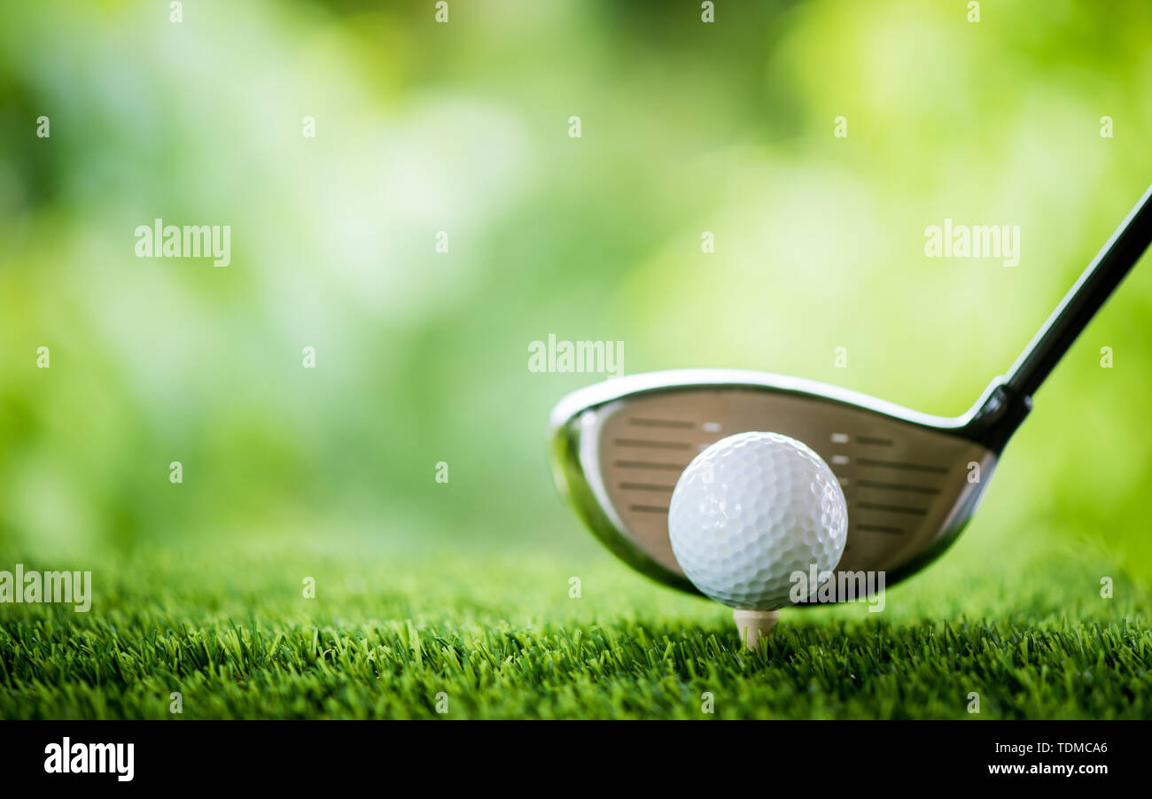 golf ball on tee with club to tee off Stock Photo