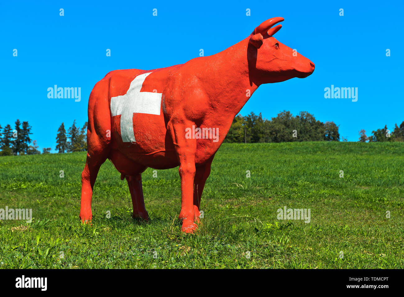 CowParade cow painted in the style of the Swiss national flag with