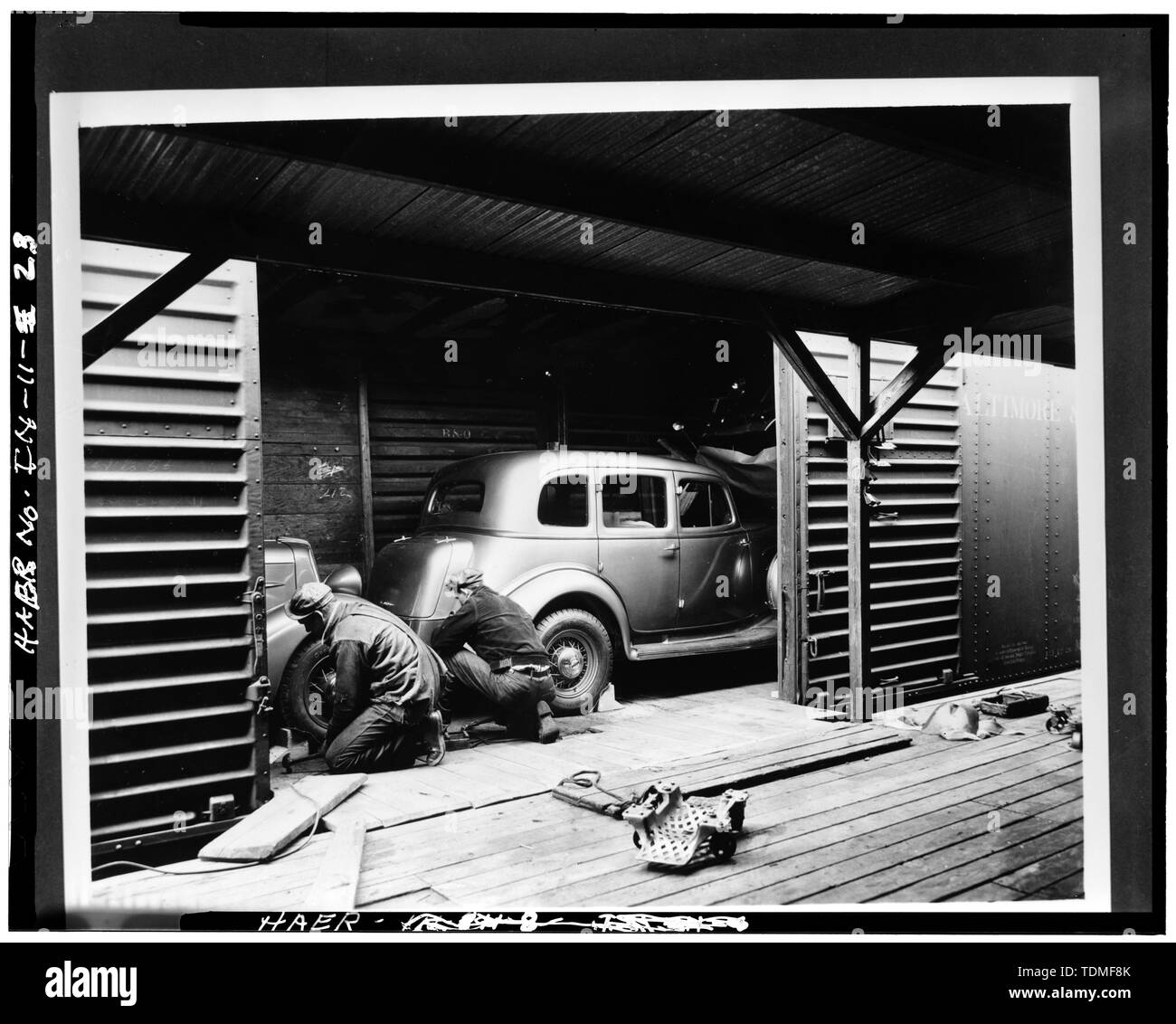PHOTOCOPY OF CA. 1934 VIEW OF AUTOS BEING SECURED INSIDE FREIGHT CAR - Lexington Motor Company, Eighteenth Street and Columbia Avenue, Connersville, Fayette County, IN; Lexington-Howard Company; Cord, Errett Lobban; Moore, John C; Stone , Kinsey; Boucher, Jack E; Rosenberg, Robert; Sackheim, Donald Stock Photo