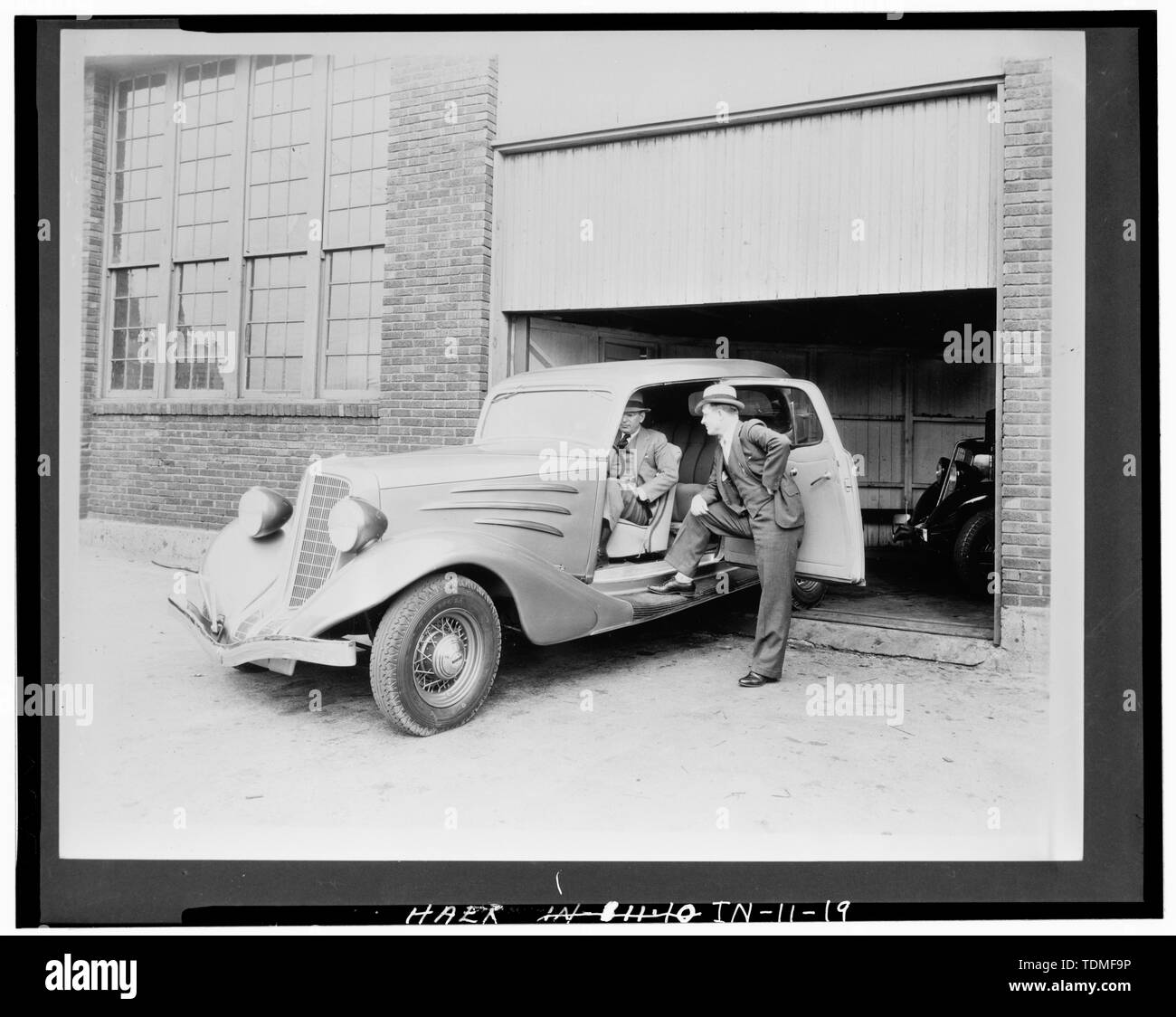 PHOTOCOPY OF CA. 1934 VIEW SHOWING TWO COMPANY OFFICIALS INSPECTING SEDAN - Lexington Motor Company, Eighteenth Street and Columbia Avenue, Connersville, Fayette County, IN; Lexington-Howard Company; Cord, Errett Lobban; Moore, John C; Stone , Kinsey; Boucher, Jack E; Rosenberg, Robert; Sackheim, Donald Stock Photo