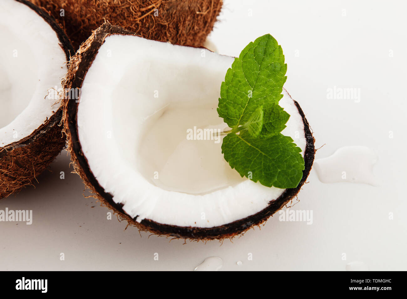 Cracked coconut isolated on white background Stock Photo