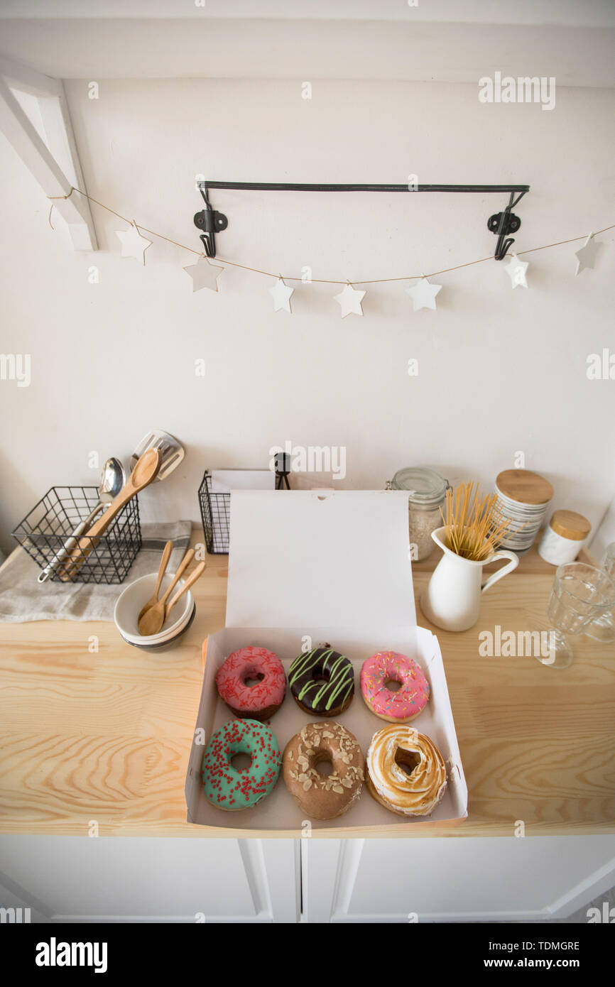 Box with doughnuts on table Stock Photo - Alamy