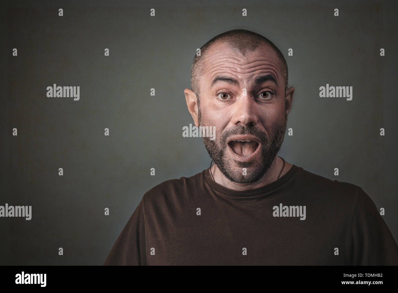 Studio Portrait Of Man With Surprised Expression Short Hair And
