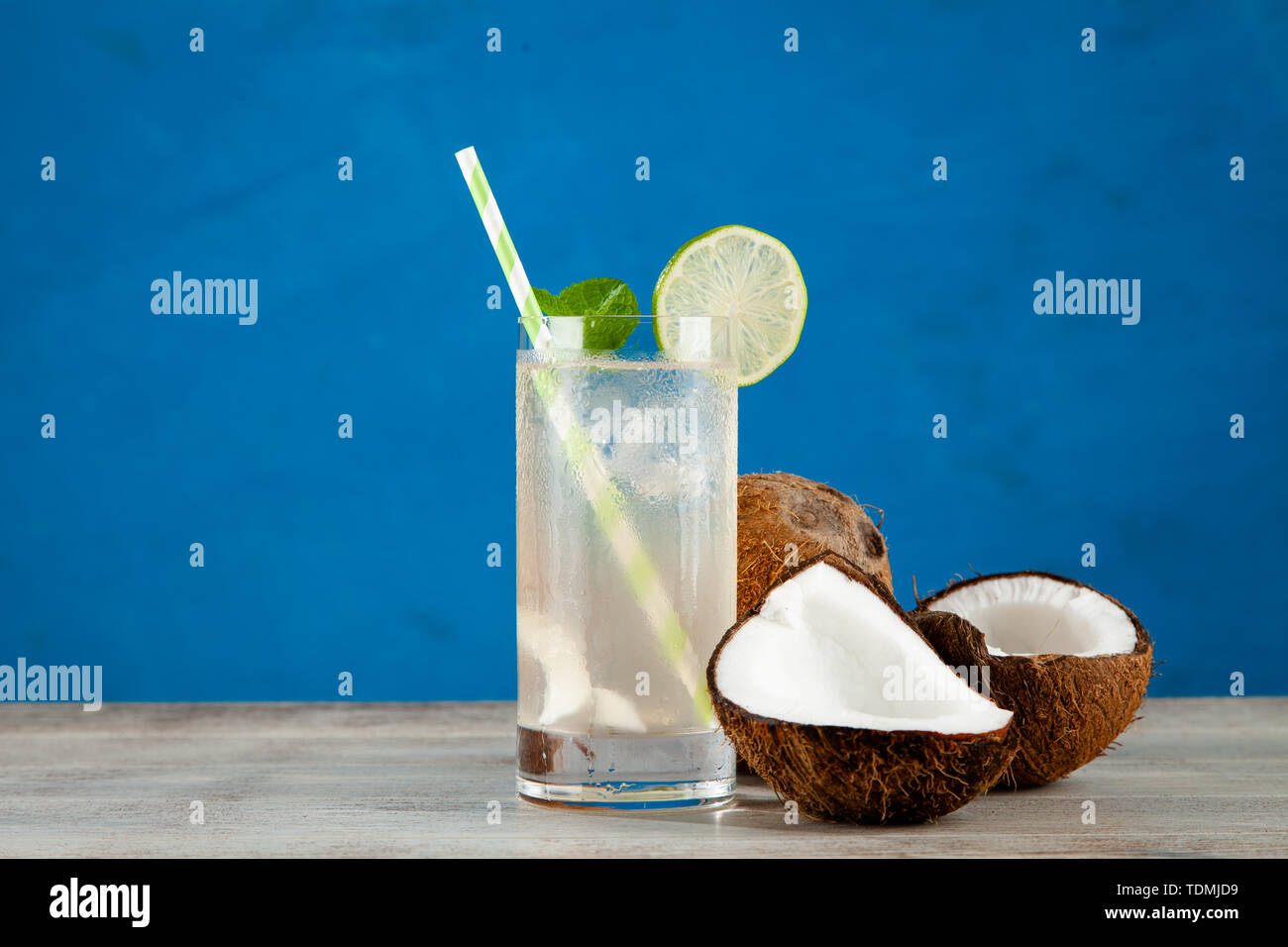 Coconut water drink on blue background Stock Photo