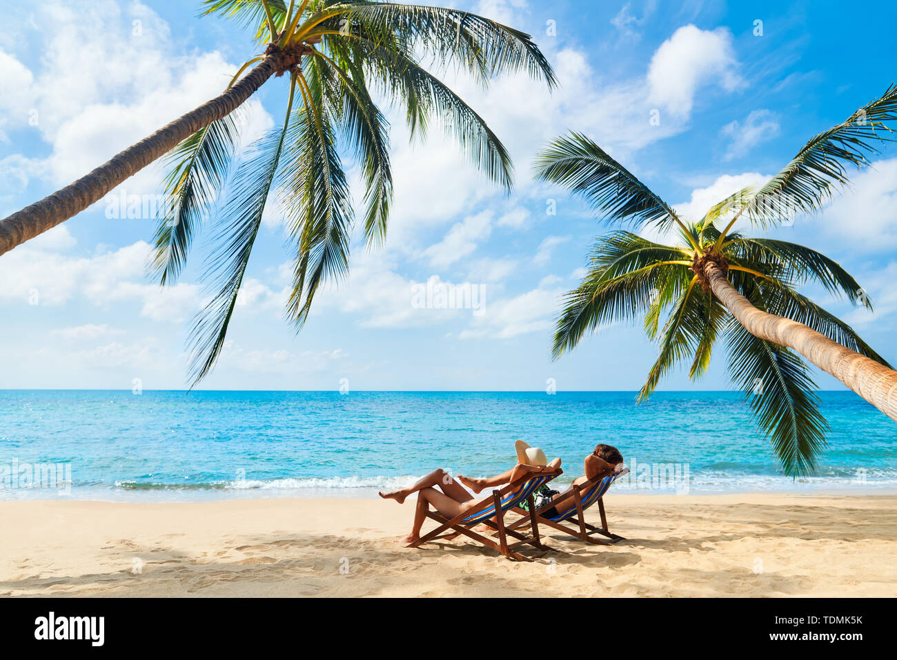 Couple relax on the beach enjoy beautiful sea on the tropical island. Summer beach vacation concept Stock Photo