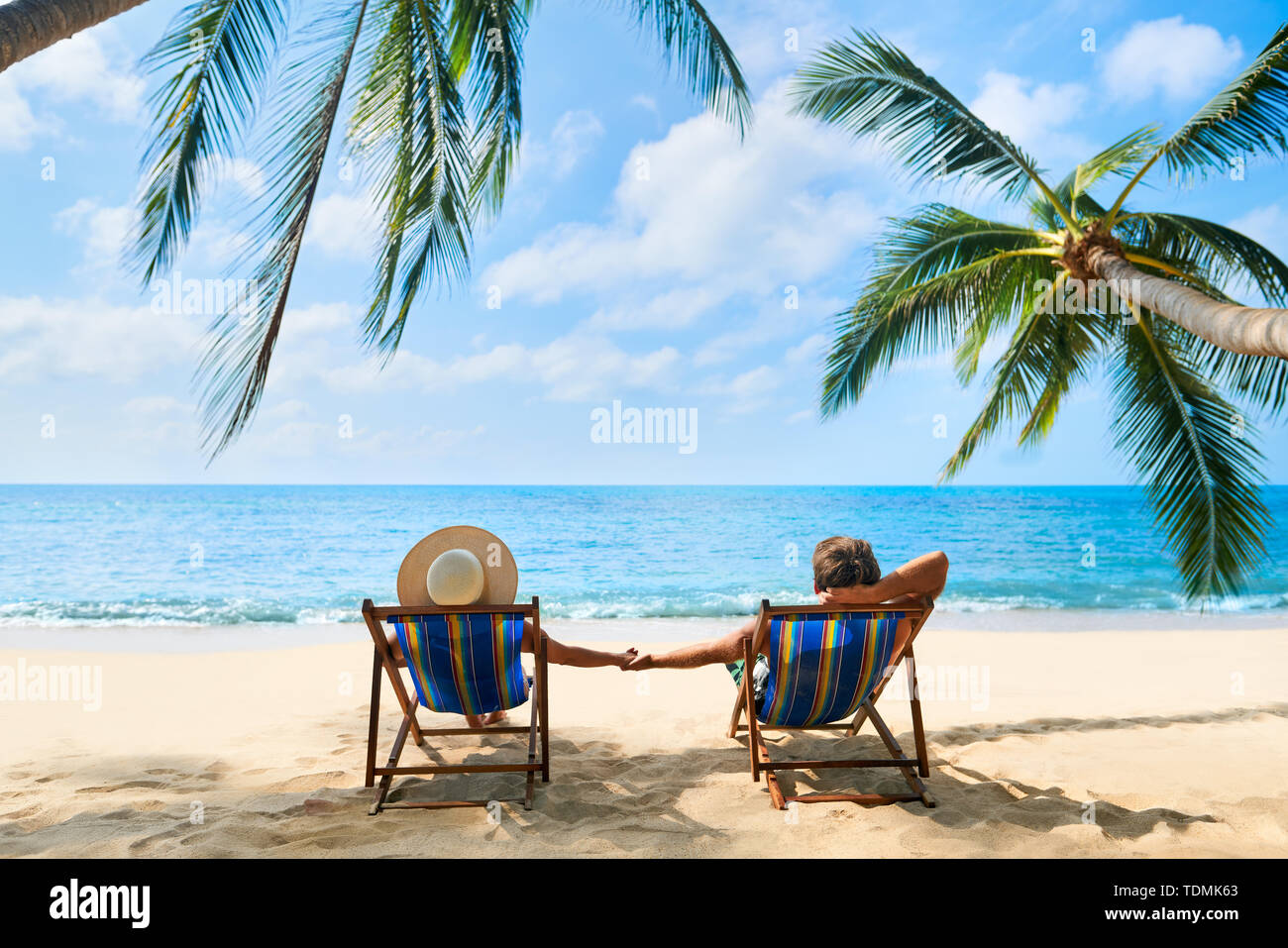Couple relax on the beach enjoying beautiful sea on the tropical island. Summer beach vacation concept Stock Photo