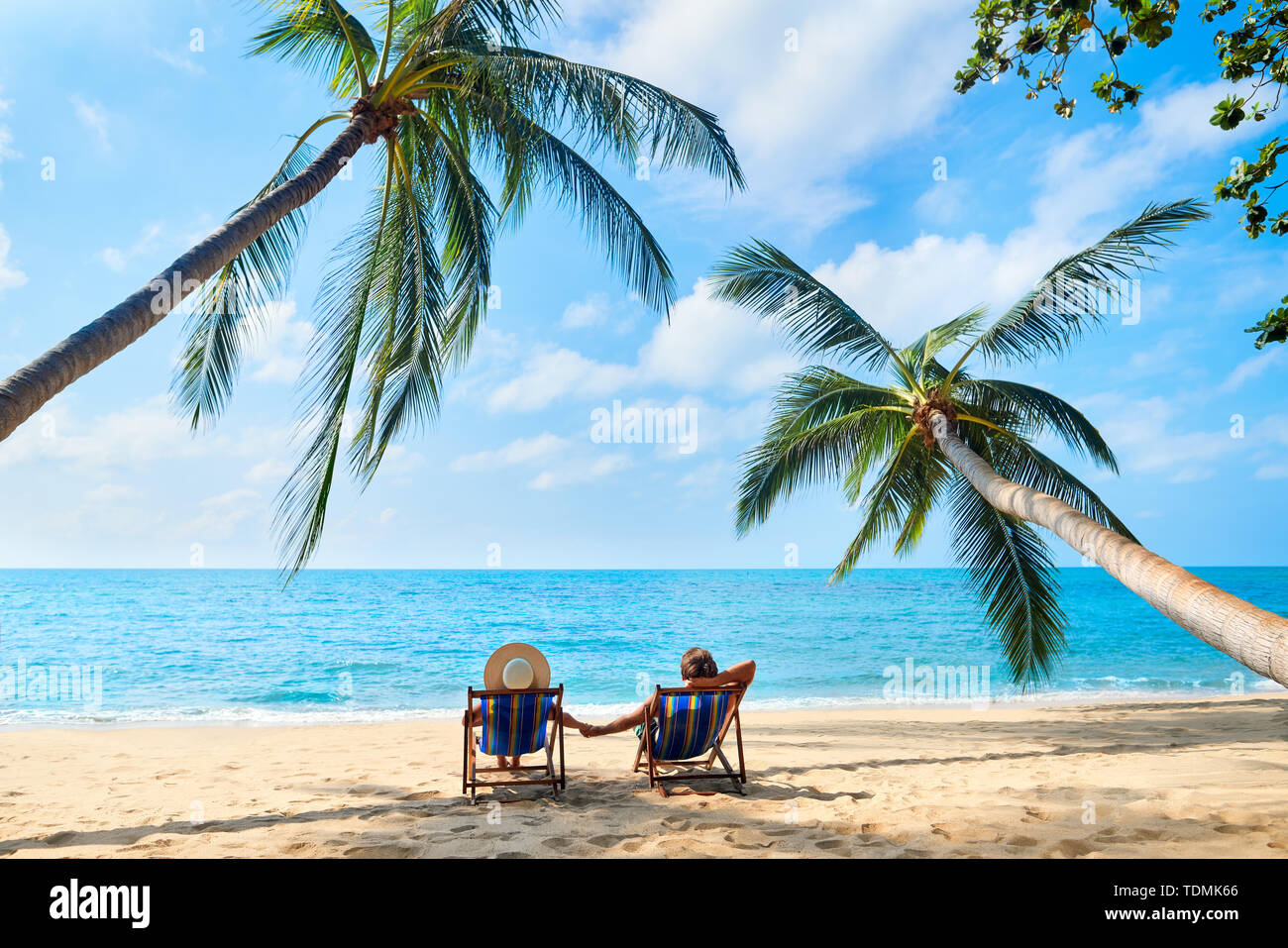 Couple relax on the beach enjoying beautiful sea on the tropical island. Summer beach vacation concept Stock Photo