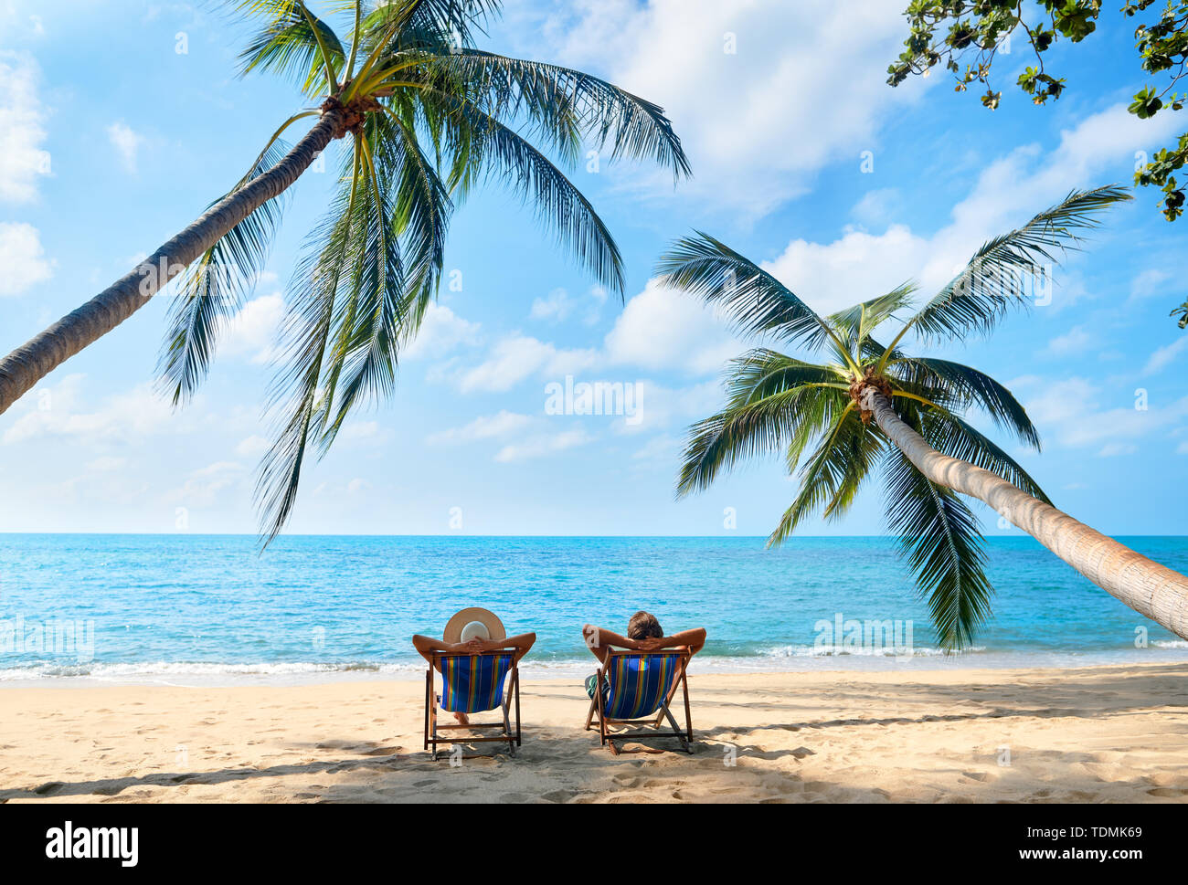 Couple relax on the beach enjoy beautiful sea on the tropical island. Summer beach vacation concept Stock Photo