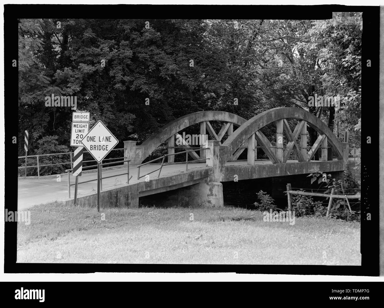 Perspective view NW by 310. Note the concrete pier extending from the bridge in the foreground. This way to allow maximum water flow during floods and rainy periods. - Weaverland Bridge, Quarry Road spanning Conestoga Creek, Terre Hill, Lancaster County, PA; Brubaker, John T; Frank H Shaw firm; Shaw, Percy A; Monier, Jean; Wunsch, R; Melan, Joseph; von Emperger, Fritz; Luten, Daniel B; Considere, M A; Jones, Howard M; Marsh, James B; McIlvain, J S; Heart, F A; Kauffmann, Paul D; Christianson, Justine, transmitter; Croteau, Todd, project manager; Flores, Roland, field team project manager; Lowe Stock Photo