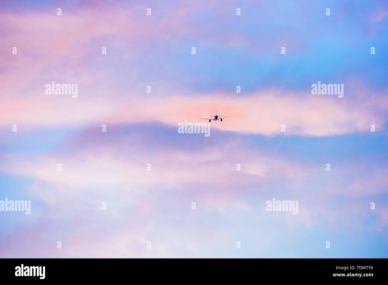 A plane through the clouds. Stock Photo