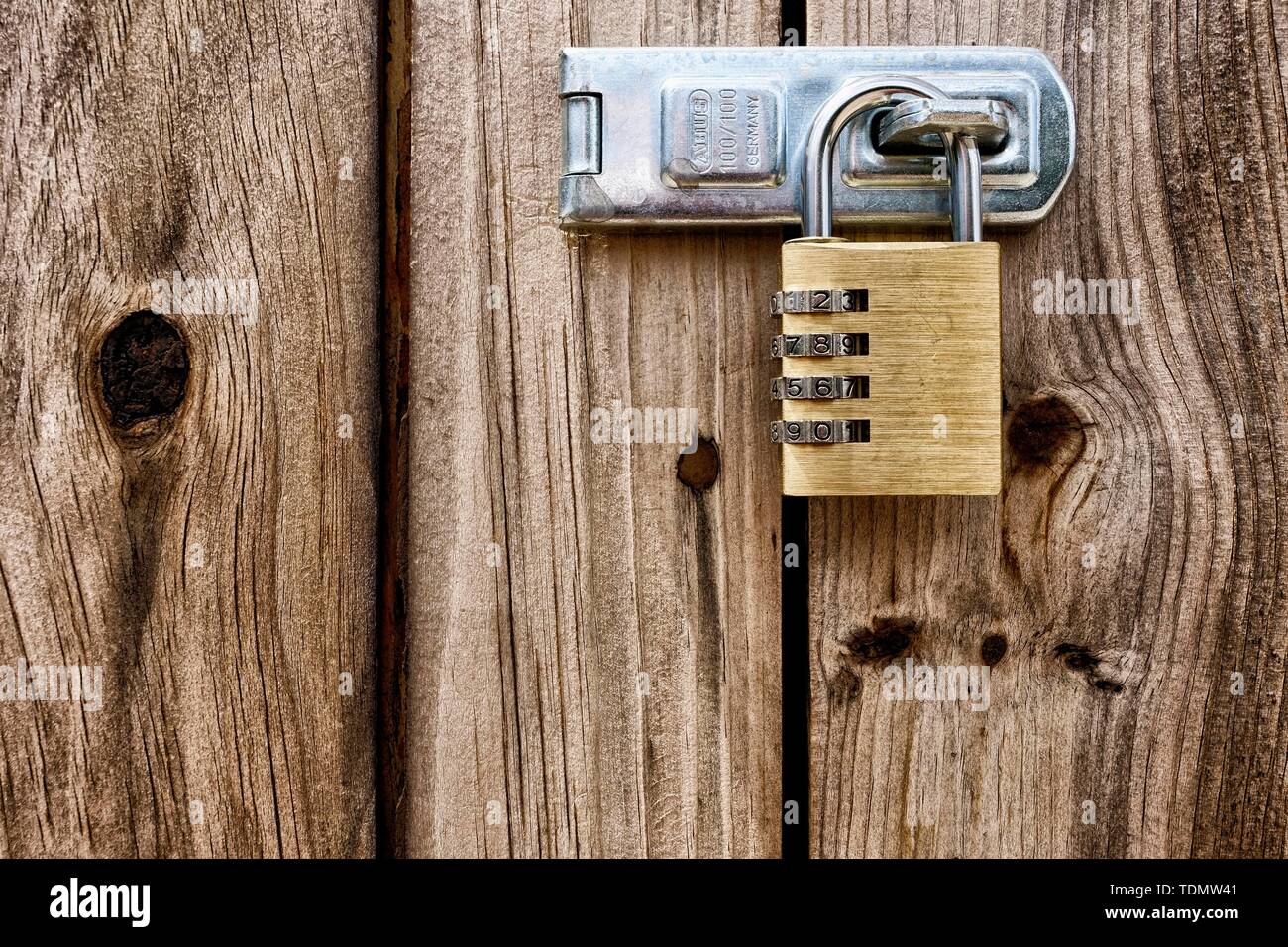 Combination lock, padlock on wooden door, closeup, Majorca, Spain