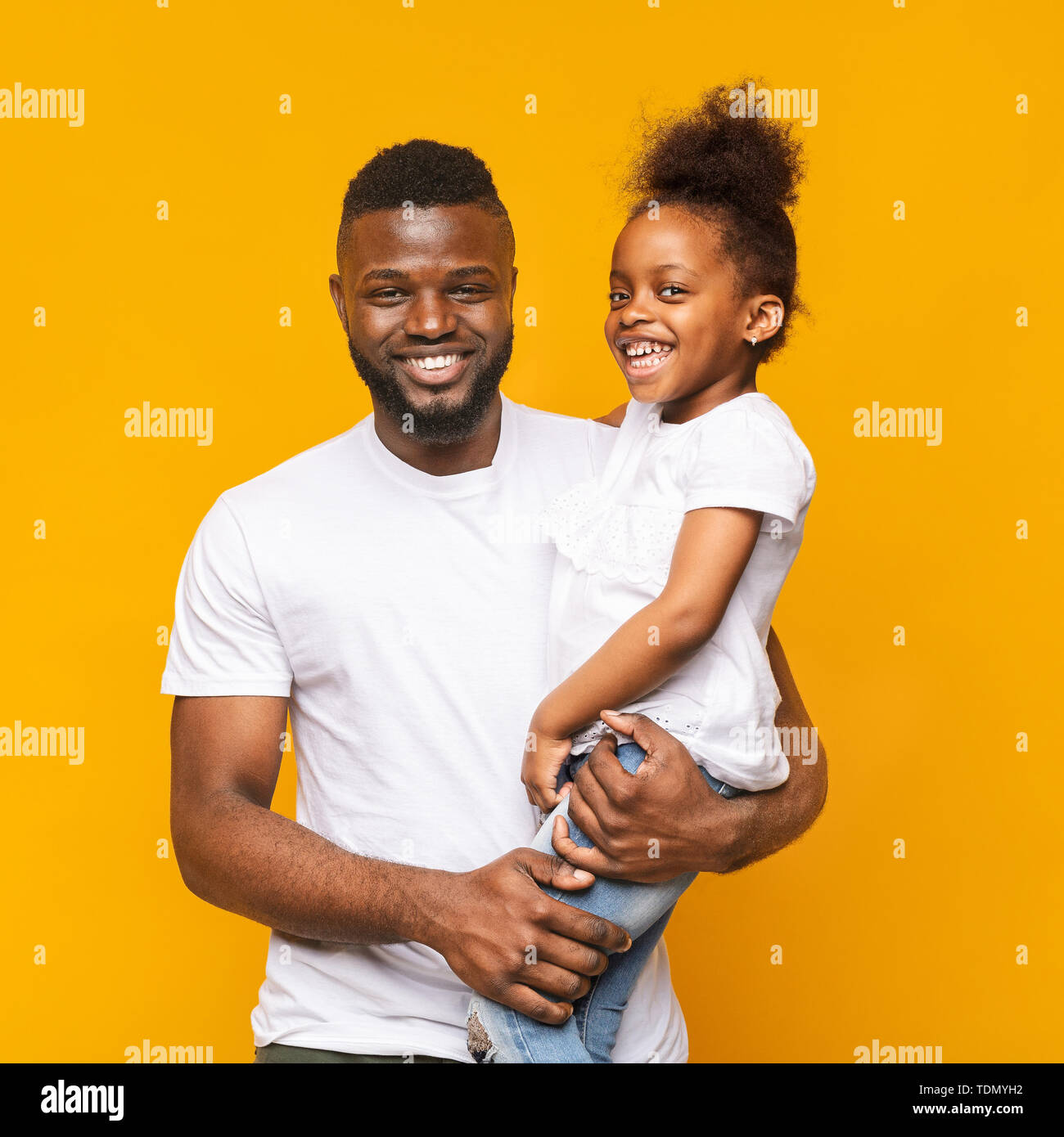 Cheerful african dad holding his cute daughter on hands Stock Photo - Alamy
