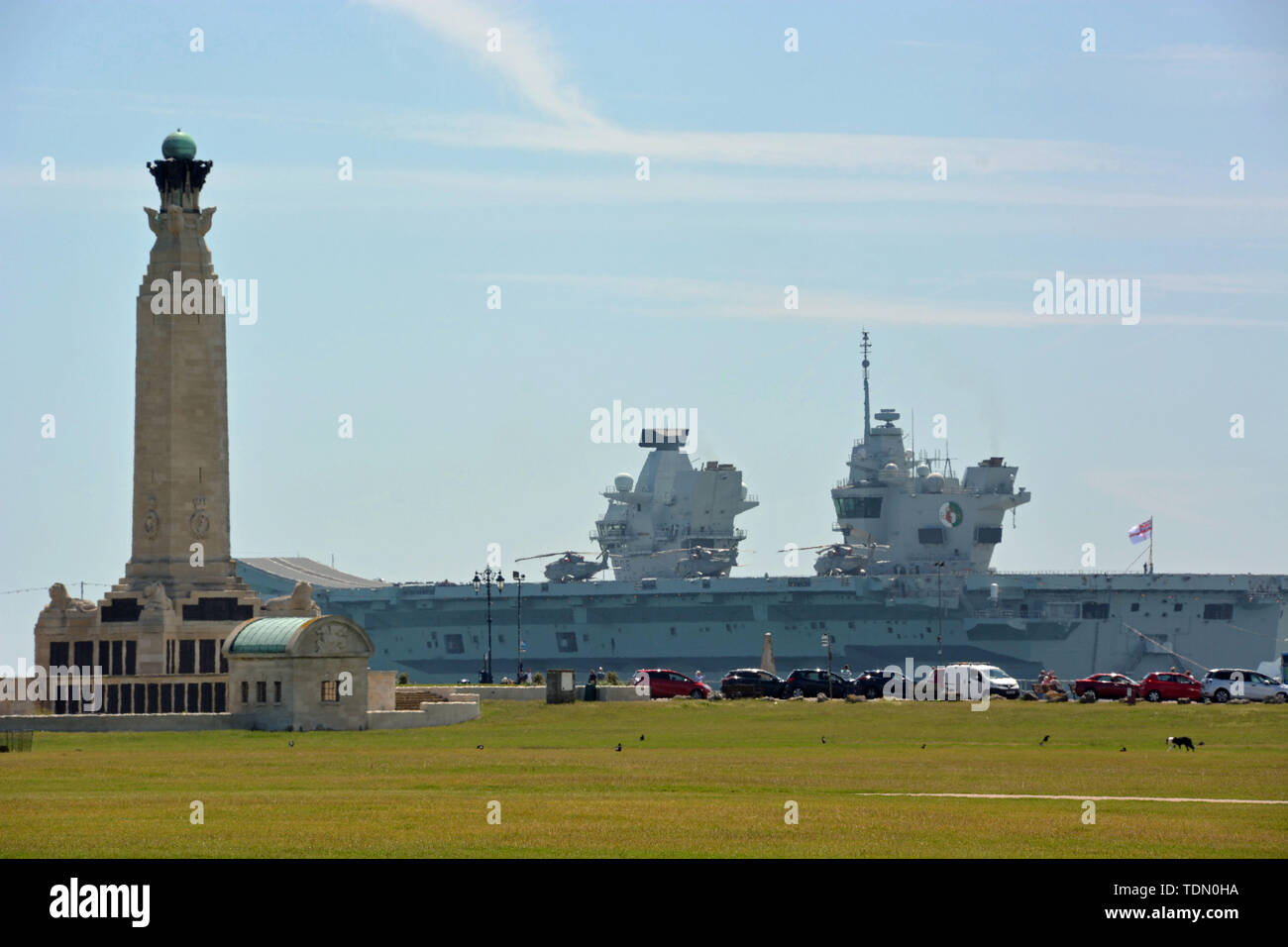 Royal Navy aircraft carrier HMS Queen Elizabeth sails past the Portsmouth Naval Memorial on Southsea Common, after sailing out of Portsmouth Harbour for sea trials. Stock Photo