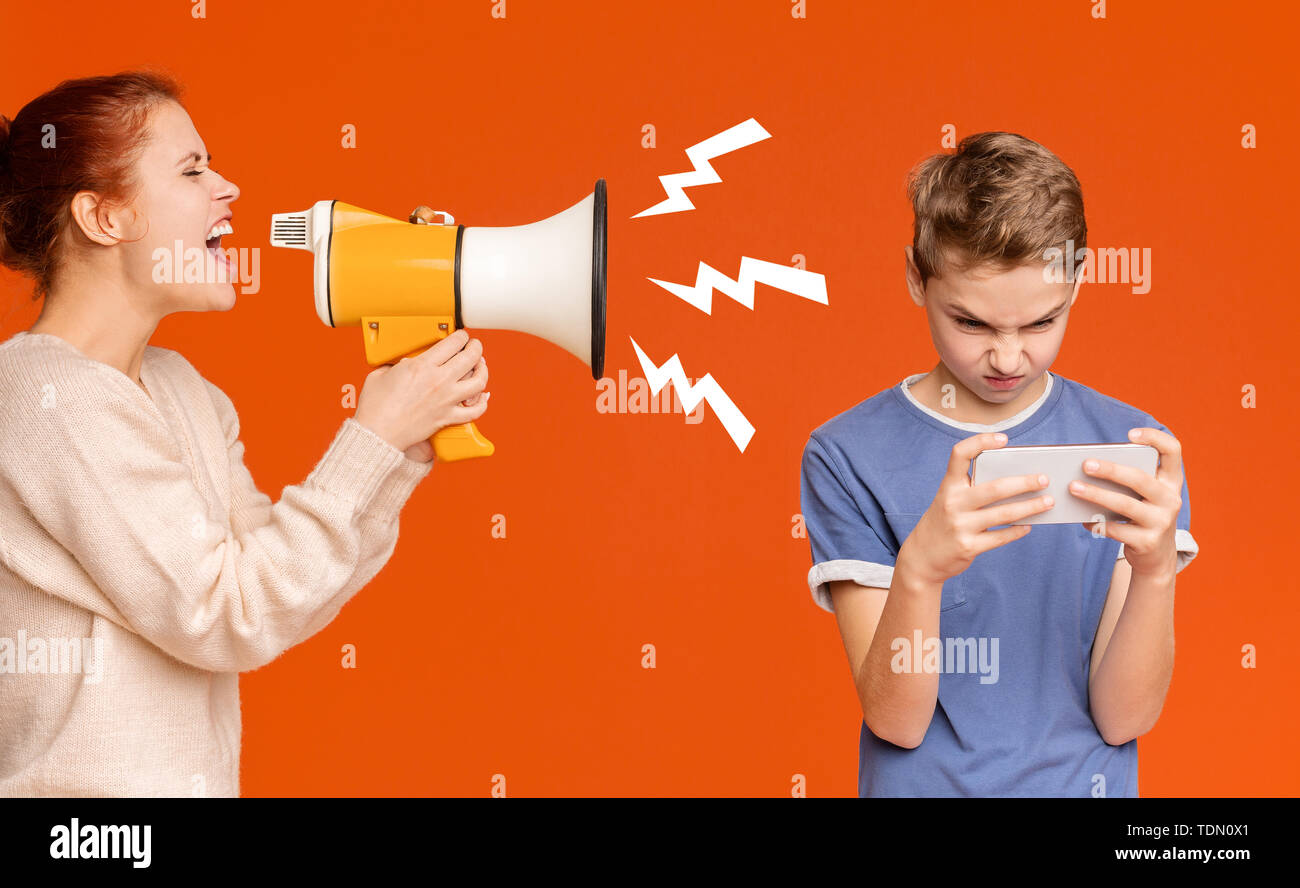 Gadget addicted boy playing mobile games on cellphone Stock Photo