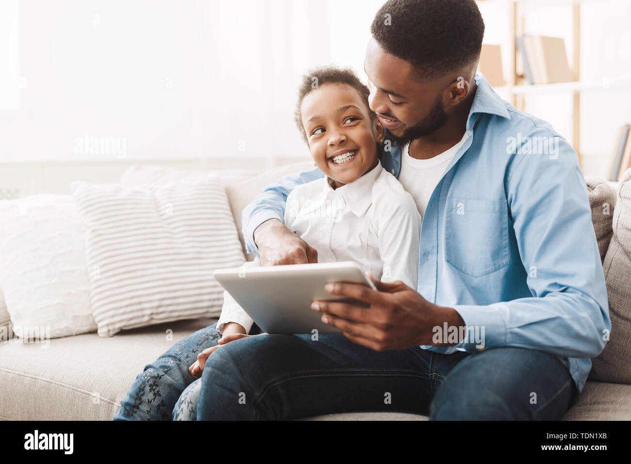 African Father And Daughter Playing On Tablet Stock Photo - Alamy