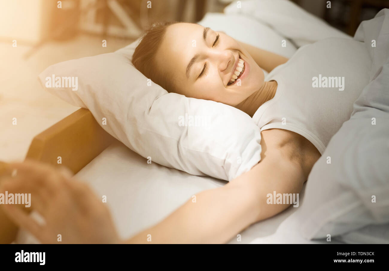 Morning Stretching. Happy Girl Lying In Bed, Waking Up Stock Photo