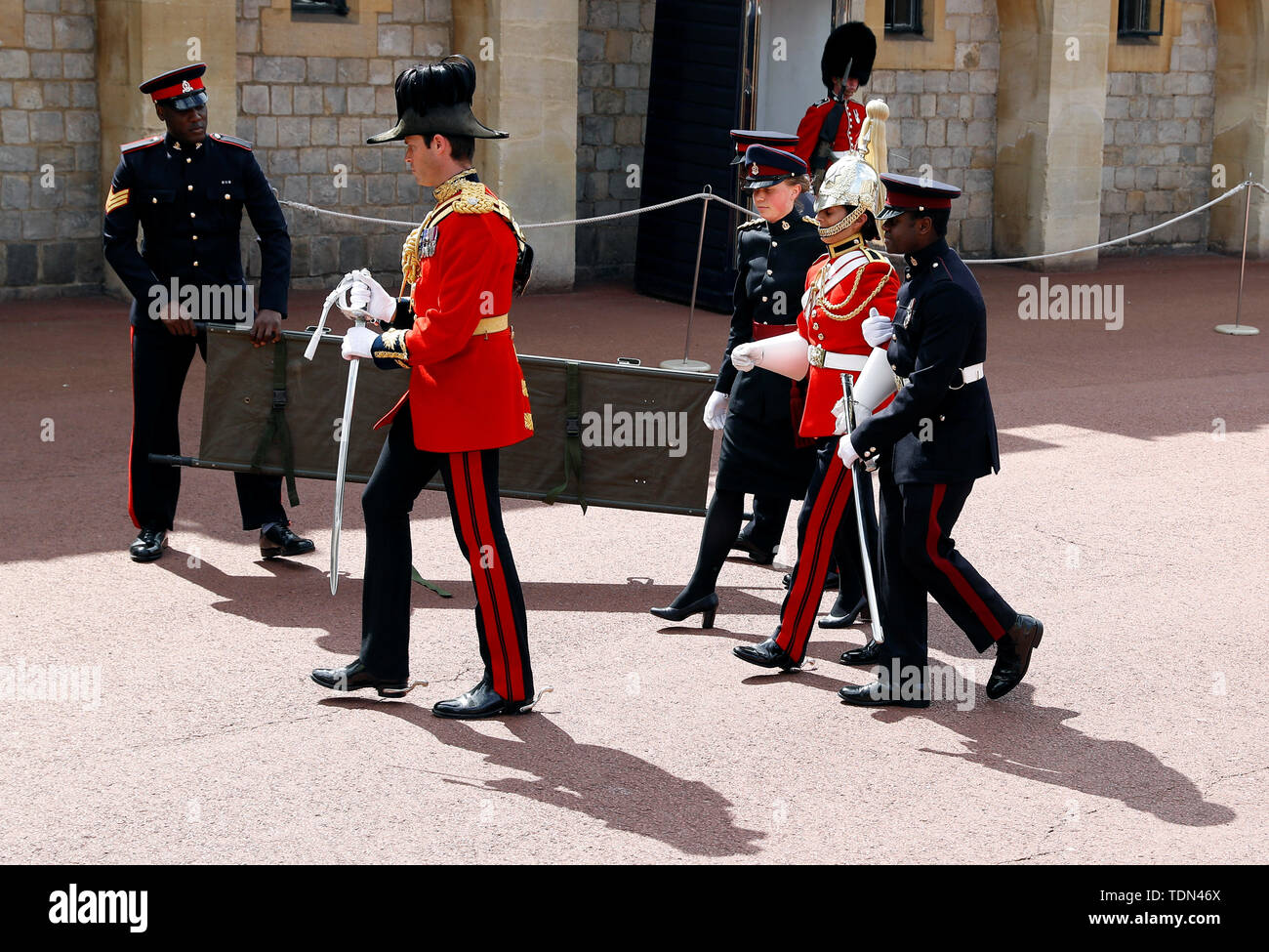 A soldier is being taken away after feeling unwell before the Order of the Garter Service at Windsor Castle, Windsor, Britain June 17, 2019. REUTERS/Peter Nicholls/Pool Stock Photo