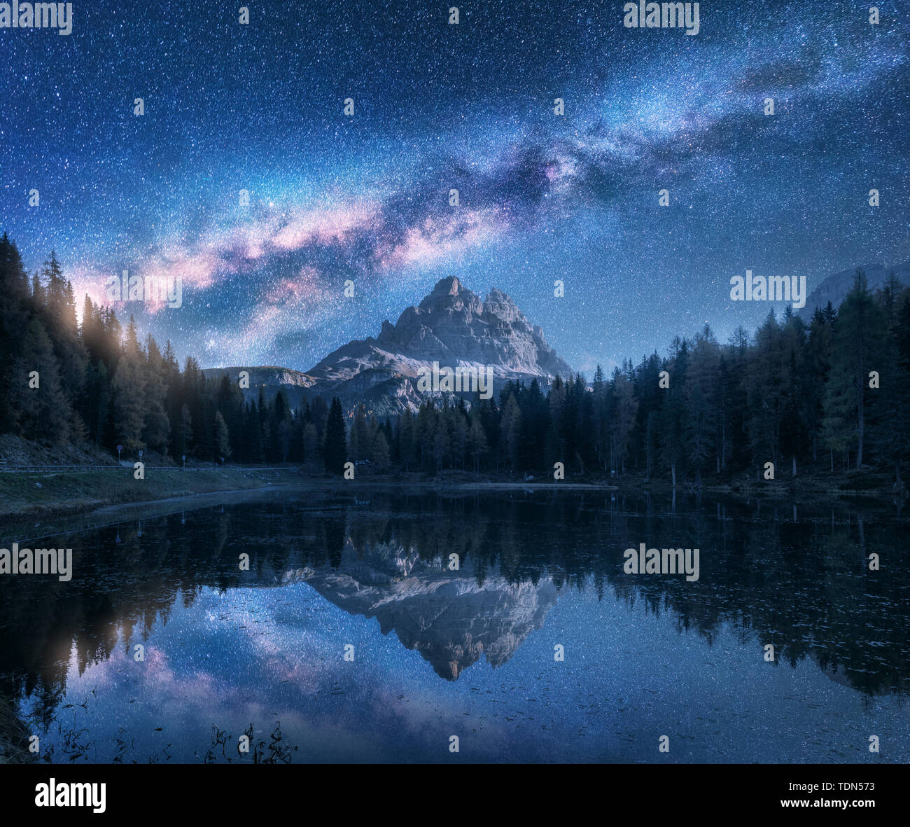 Milky Way over mountains and Antorno lake at night Stock Photo